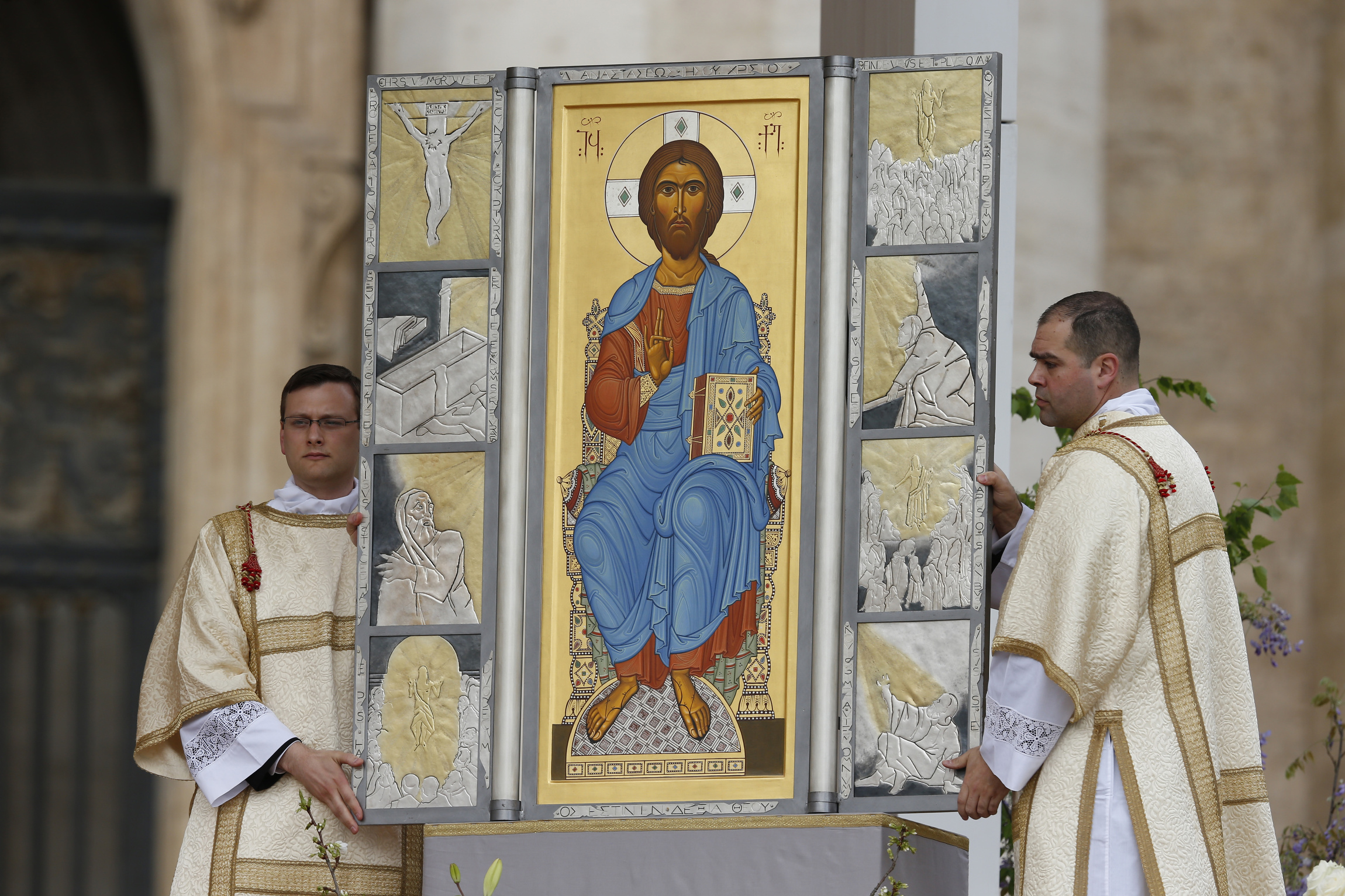 Altar servers unveil image of Jesus as pope celebrates Easter Mass in St. Peter's Square at Vatican