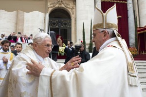 Retired Pope Benedict XVI embraces Pope Francis before canonization Mass at Vatican