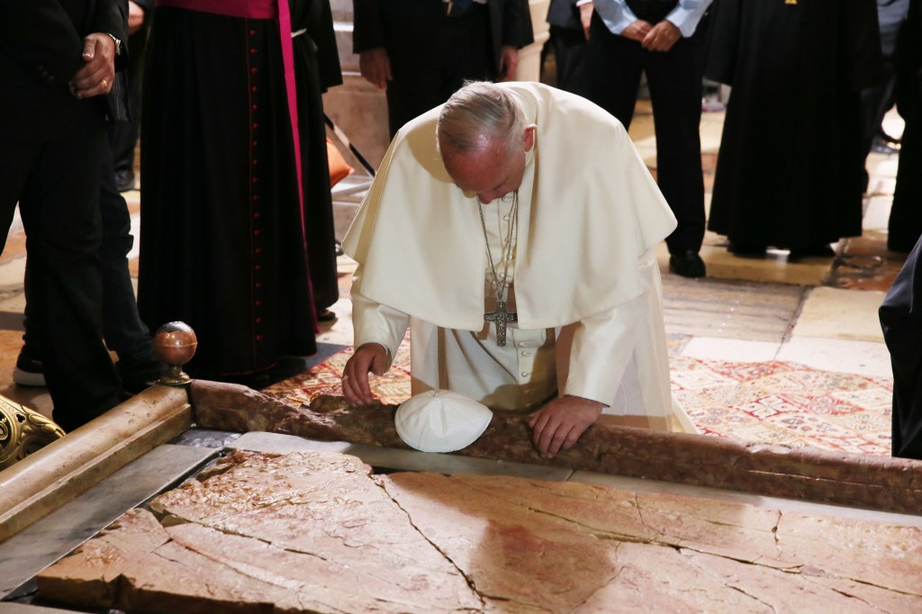 Pope kneels before Stone of Unction in Jerusalem's Church of the Holy Sepulcher