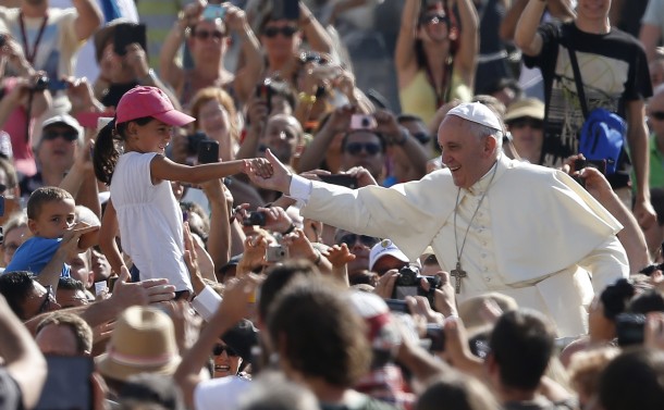 Pope Francis greets girl as he arrives to lead general audience