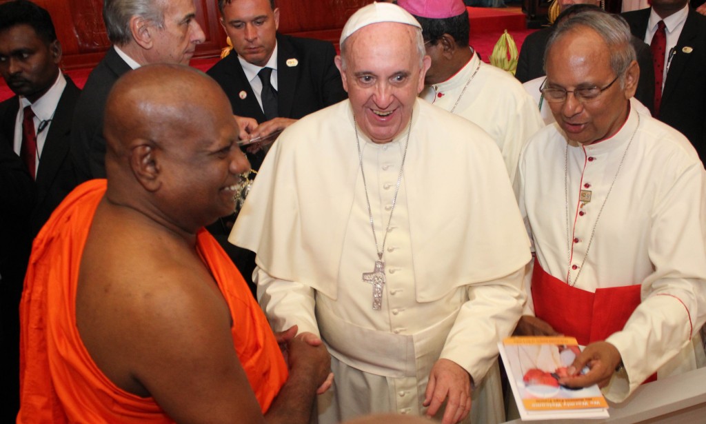 Pope Francis is greeted by a senior monk  during a meeting with religious leaders in Sri Lanka