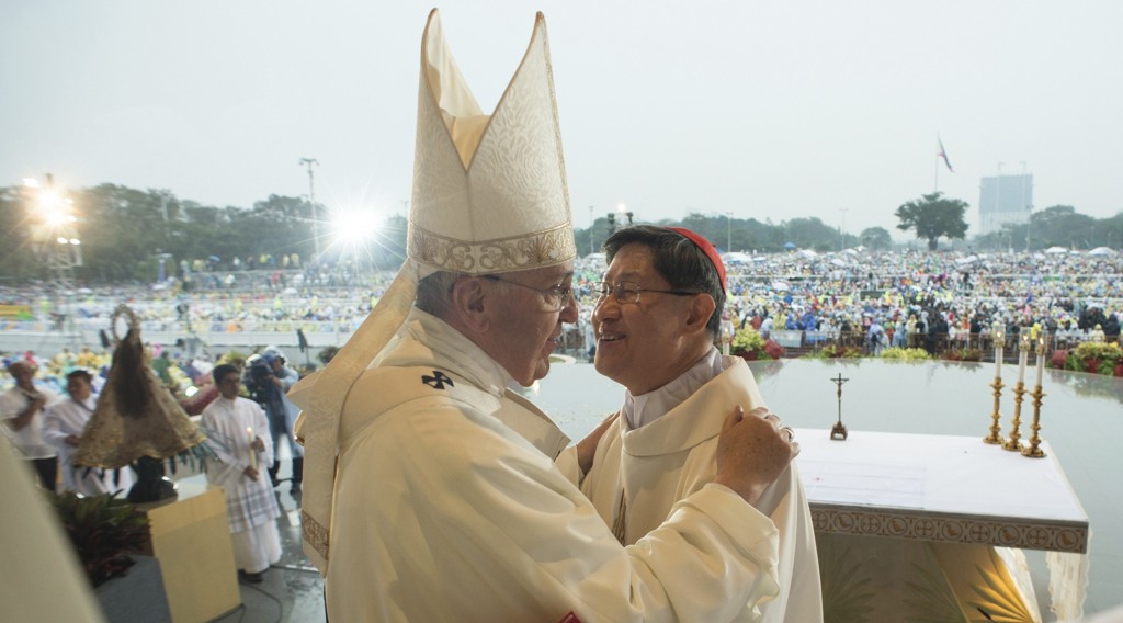 Pope Francis embraces Cardinal Tagle as he celebrates a Mass at Rizal Park in Manila