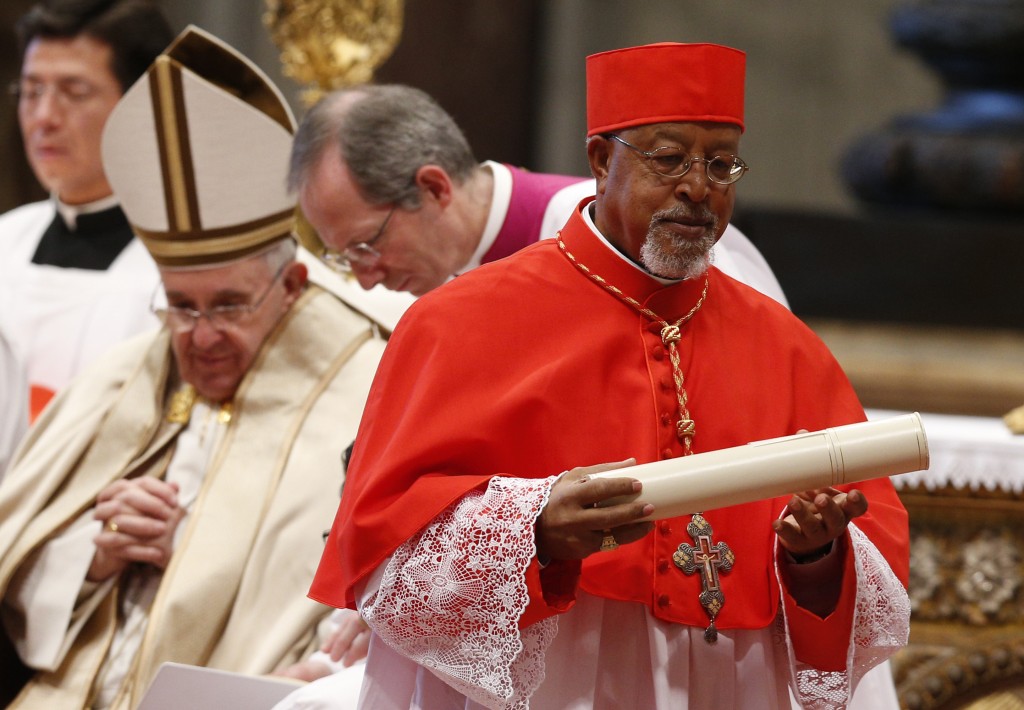 New Cardinal Souraphiel carries scroll during consistory in St. Peter's Basilica at Vatican