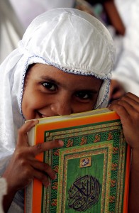 ACHENESE GIRL HOLDS COPY OF QURAN