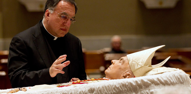Fr. Thomas Rosica, C.S.B., blessing the body of Cardinal John Foley in the Cathedral Basilica of Sts. Peter and Paul, Philadelphia, Pennsylvania, prior to the funeral mass.