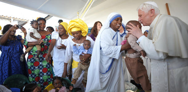 POPE BENEDICT KISSES CHILD DURING VISIT TO PARISH IN BENIN