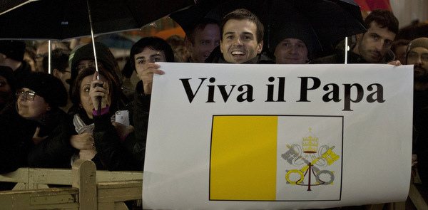 Pilgrim holds banner after Pope Francis elected at Vatican