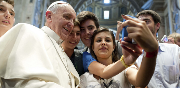 Pope Francis poses with youths during meeting with young people in St. Peter's Basilica at Vatican