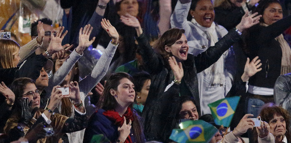 Pilgrims react as pope arrives for World Youth Day welcoming ceremony on Copacabana beach in Rio