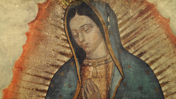 WOMAN LAYS HAND ON IMAGE OF OUR LADY OF GUADALUPE ON DISPLAY AT NEW YORK CATHOLIC CHURCH