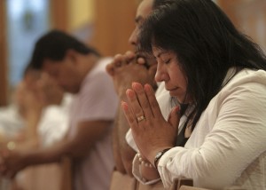 People pray during Spanish-language Mass in Riverhead, N.Y.
