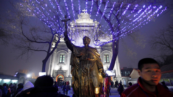CHURCH-GOERS GATHER OUTSIDE BEIJING CATHEDRAL BEFORE CHRISTMAS EVE MASS