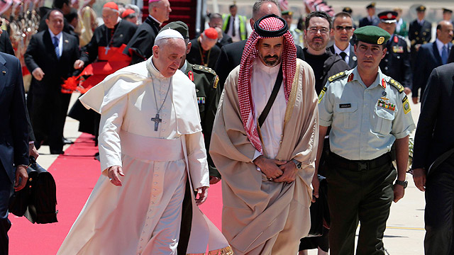 Pope Francis is welcomed by Jordan's Prince Ghazi bin Muhammad bin Talal after arrival at Queen Alia International Airport in Amman