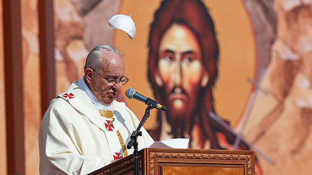 Pope Francis' skull cap is blown into the air as he delivers his homily during Mass at Amman International Stadium in Jordan May 24. The pope is making a three-day visit to the Holy Land, spending one day each in Jordan, the Palestinian territories and I srael. (CNS photo/Paul Haring)