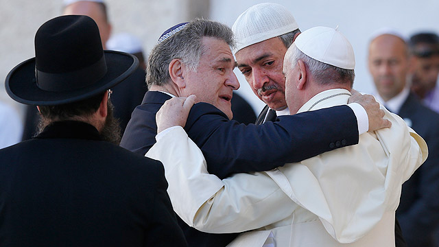 Pope Francis is embraced by Argentine Rabbi Abraham Skorka as he leaves after praying at the Western Wall in Jerusalem May 26. On the right is Omar Abboud, Muslim leader from Argentina. "We did it," Rabbi Skorka said he told the pope and Abboud. The pope 's message contained the text of the Our Father and of the 122nd Psalm, traditionally prayed by Jewish pilgrims who travel to Jerusalem.(CNS photo/Paul Haring) (May 26, 2014) (CNS photo/Paul Haring) 