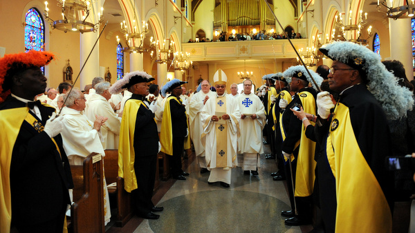 New bishop of Houma-Thibodaux processes into Louisiana cathedral at start of installation Mass