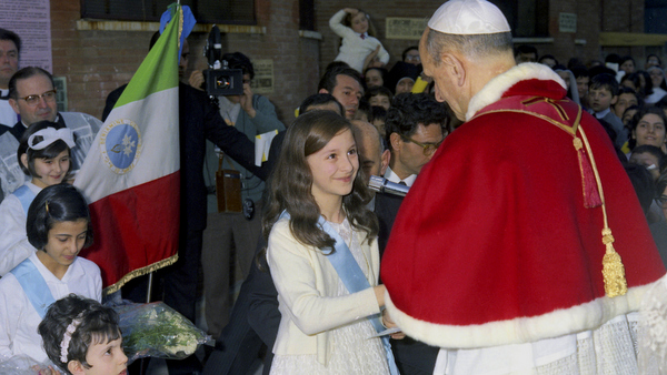 File photo of Pope Paul VI greeting girl during Rome parish visit in 1968