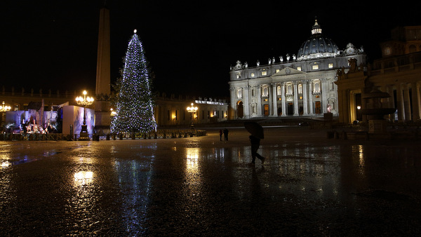 The St. Peter's Square Christmas tree is reflected in a puddle of slush after a five-minute hail storm hit the Vatican Feb. 1. The storm briefly whitened Rome's streets, bringing cheer to locals, who rarely see snow. (CNS photo/Paul Haring)