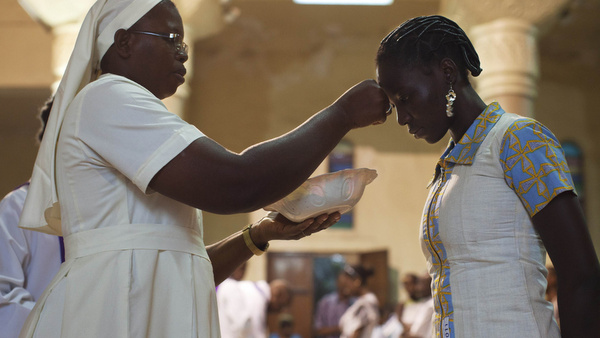 Nun distributes ashes during Ash Wednesday Mass at cathedral in Mali