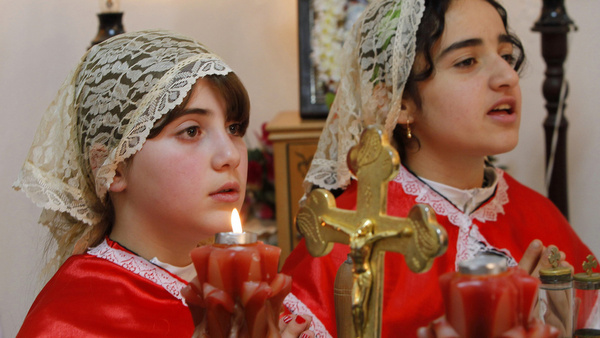 YOUNG IRAQI WOMAN ATTEND EASTER MASS AT CHALDEAN CATHOLIC CHURCH IN JORDAN