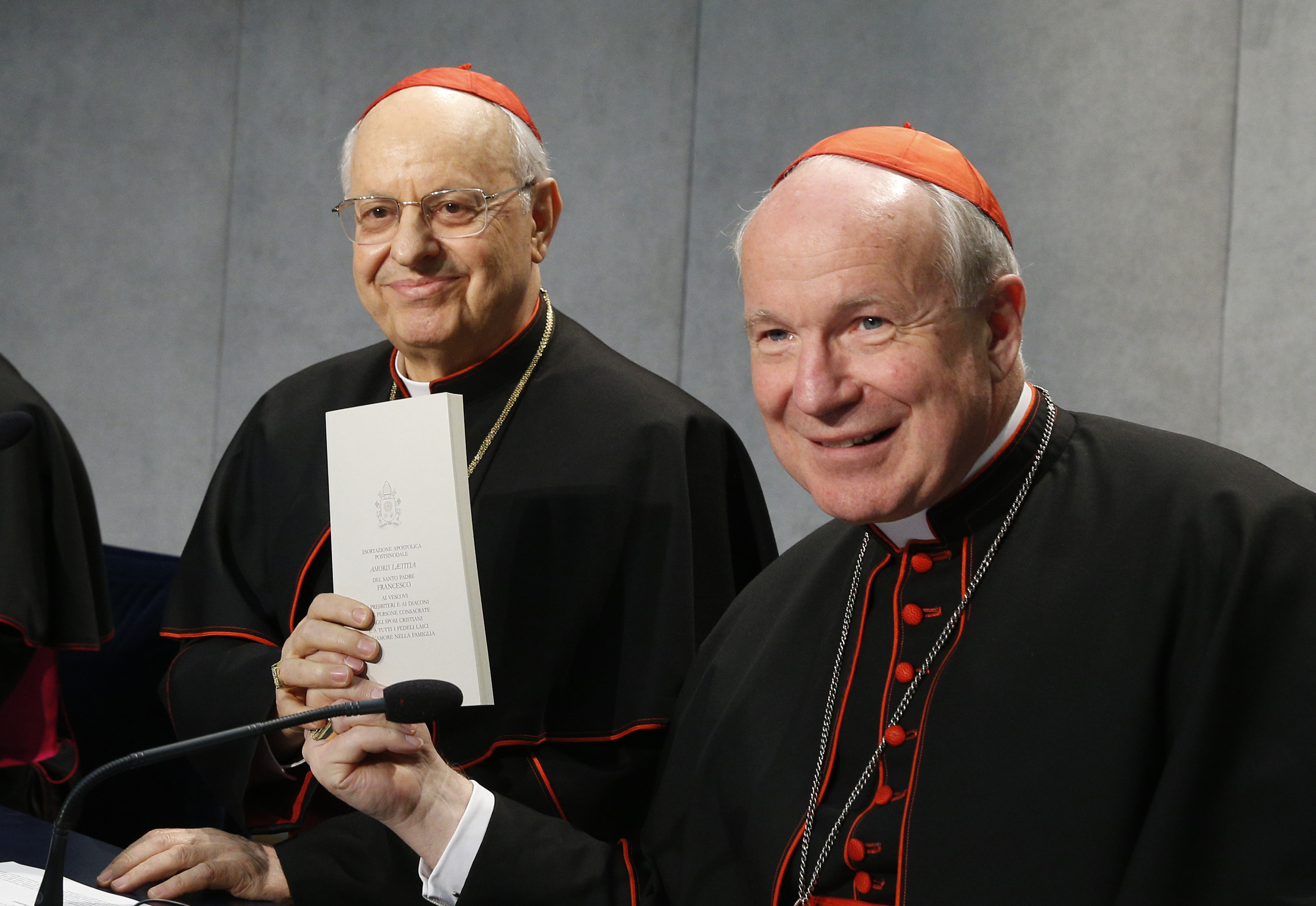 Cardinal Lorenzo Baldisseri, general secretary of the Synod of Bishops, and Austrian Cardinal Christoph Schonborn, holds a copy of Pope Francis' apostolic exhortation on the family, "Amoris Laetitia" ("The Joy of Love"), during a news conference for the document's release at the Vatican April 8. The exhortation is the concluding document of the 2014 and 2015 synods of bishops on the family. (CNS photo/Paul Haring) See POPE-FAMILY-EXHORTATION and VATICAN-LETTER-FAMILY April 8, 2016.