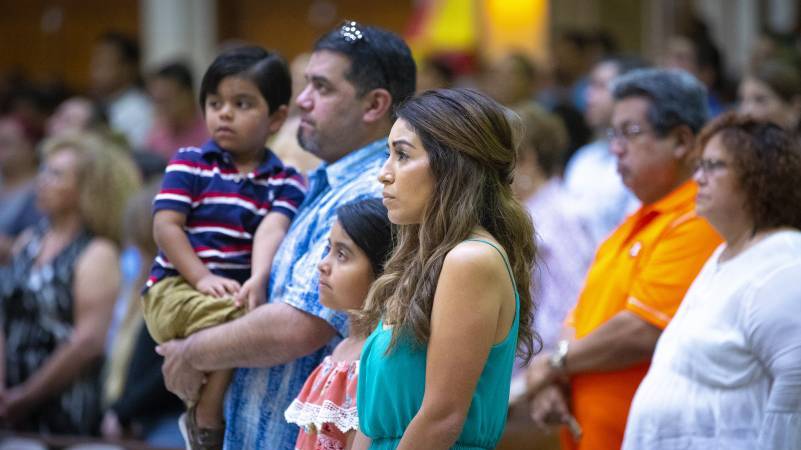 Family standing during Mass