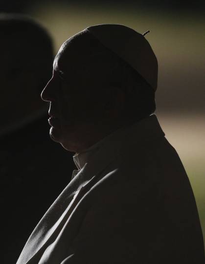 Silhouette photo of Pope Francis taken as he arrived to lead the Way of the Cross outside the Colosseum in Rome March 30. (CNS photo/Paul Haring)