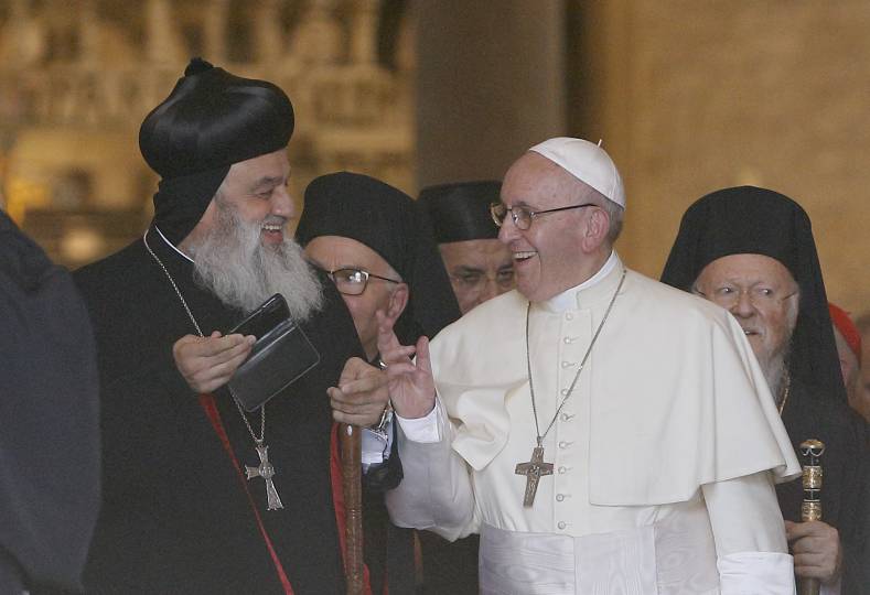 Pope Francis talks with Syriac Orthodox Patriarch Ignatius Aphrem II of Antioch as they leave the Basilica of St. Nicholas in Bari, Italy, July 7. The pope was meeting with leaders of Christian churches for an ecumenical day of prayer for peace in the Middle East. (CNS photo/Paul Haring)