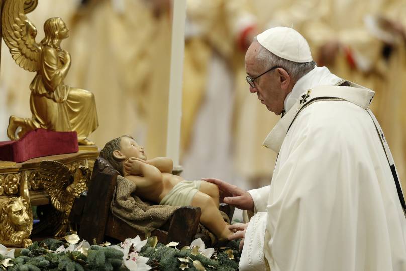 Pope Francis reverences a figurine of the baby Jesus at the start of a Mass marking the feast of the Epiphany in St. Peter's Basilica at the Vatican Jan. 6. (CNS photo/Paul Haring)