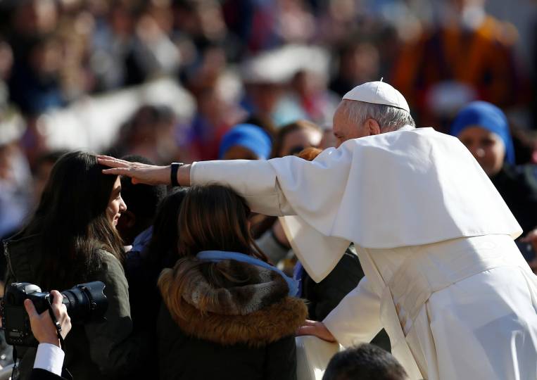 Pope Francis blesses a woman as he arrives for his general audience in St. Peter's Square at the Vatican Feb. 27, 2019. (CNS photo/Yaraara Nardi, Reuters)
