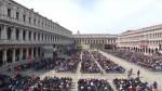 Large crowd in historic square sits in columns listening to Pope Francis' homily