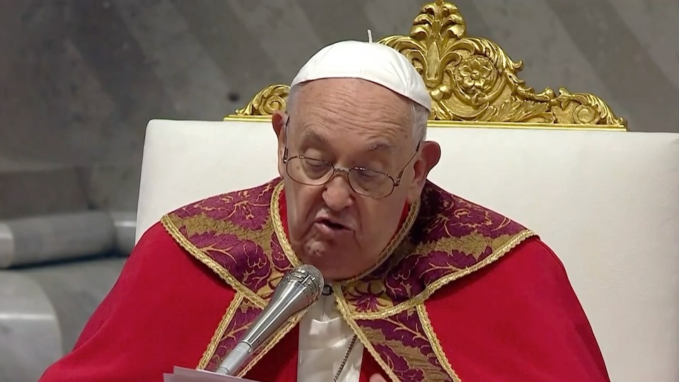 Closeup of Pope Francis in red cope and white zucchetto sitting giving a homily
