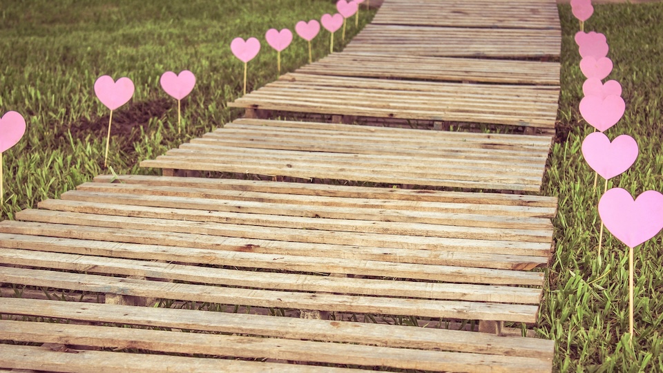 boardwalk path lined with paper hearts