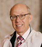 Square photo of a smiling man in a tallit.
