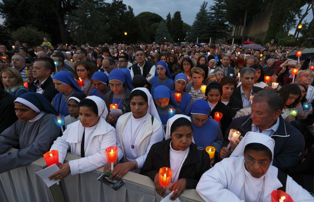 People attend Marian prayer service led by Pope Francis at grotto of Our Lady of Lourdes in Vatican Gardens