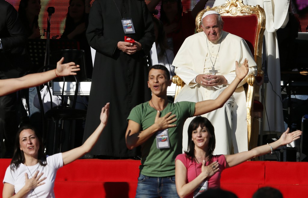 Pope Francis looks on as dancers perform during encounter with Catholic charismatics at Olympic Stadium in Rome