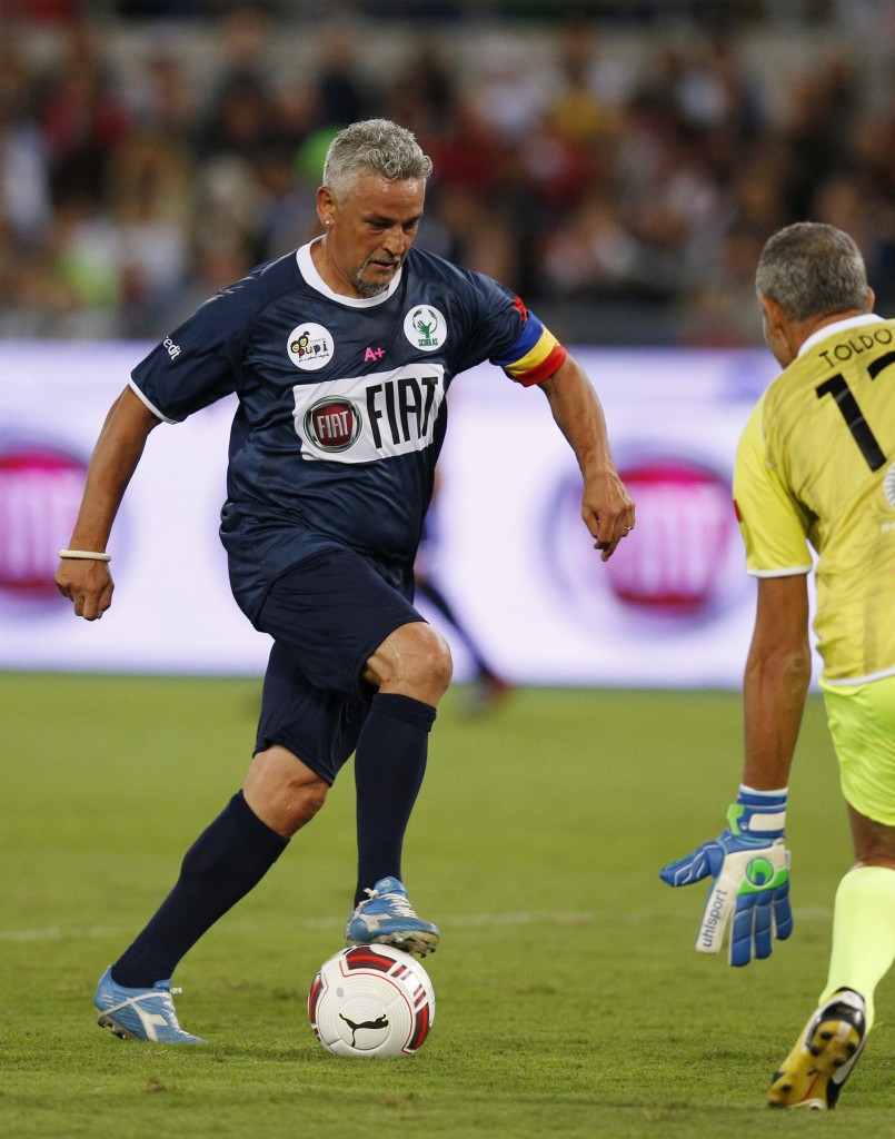 Former Italian soccer player Roberto Baggio prepares to score against retired Italian goalie Francesco Toldo during 'Interreligious Match for Peace'