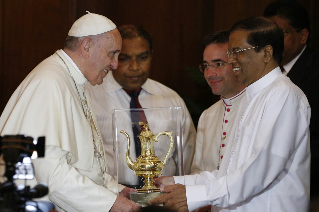 Pope Francis accepts gift during visit with Sri Lankan President Maithripala Sirisena in a presidential office in Colombo