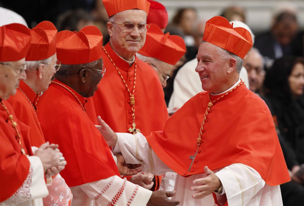 New Cardinal Dew greets Cardinal Arinze during consistory at which Pope Francis created 20 new cardinals in St. Peter's Basilica at Vatican